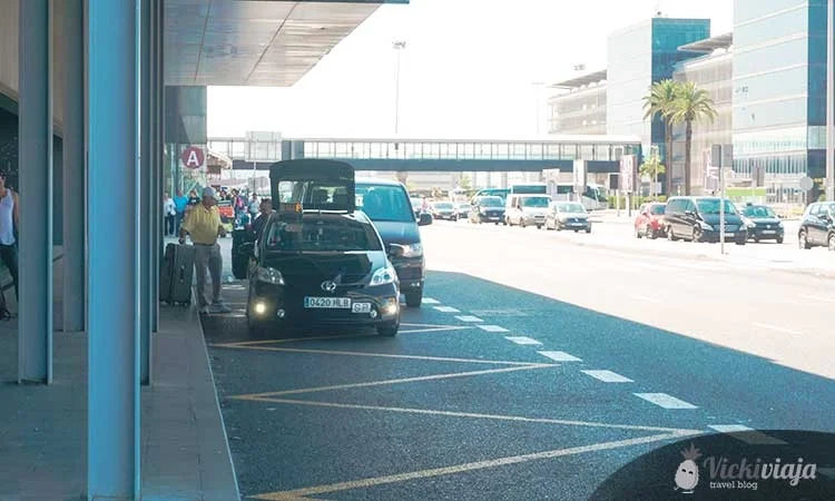 Car picks up travelers at Barcelona airport, taxi