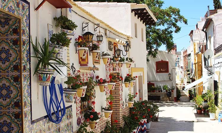 Barrio de Santa Cruz en Alicante, blumenbeschmückte weiße Gebäude