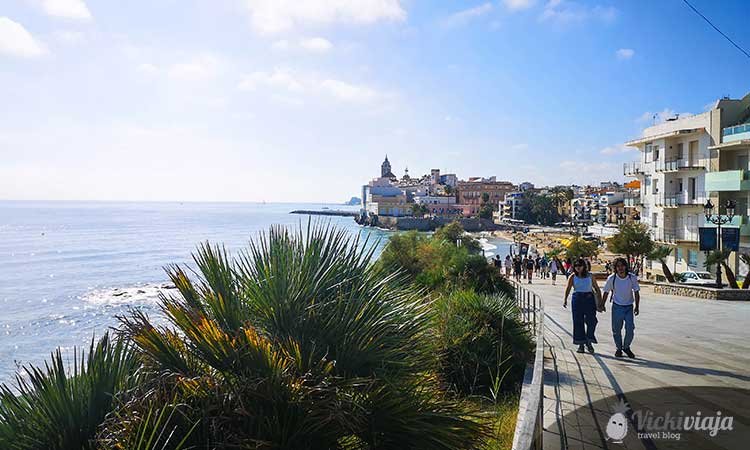 Paseo Marítimo in Sitges, beach promenade with visitors along the coast