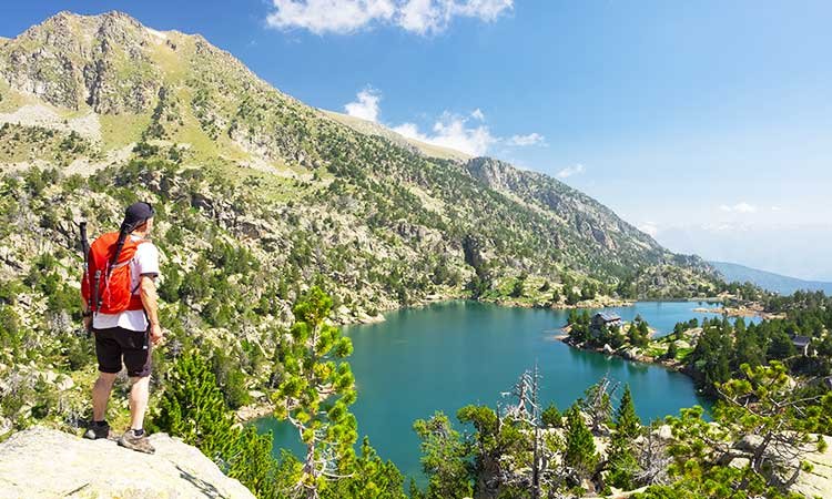 Aigüestortes National Park in the Pyrenees, hiker overlooking lake