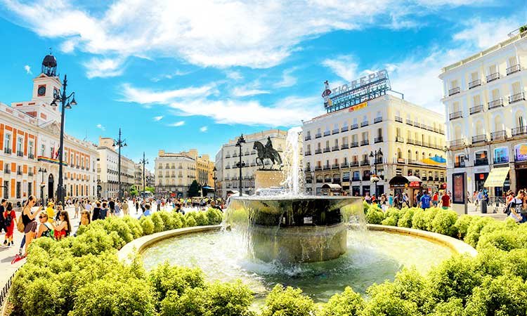 puerta de sol, square in madrid, view of fountain with square and statues in the background, surrounded by buildings