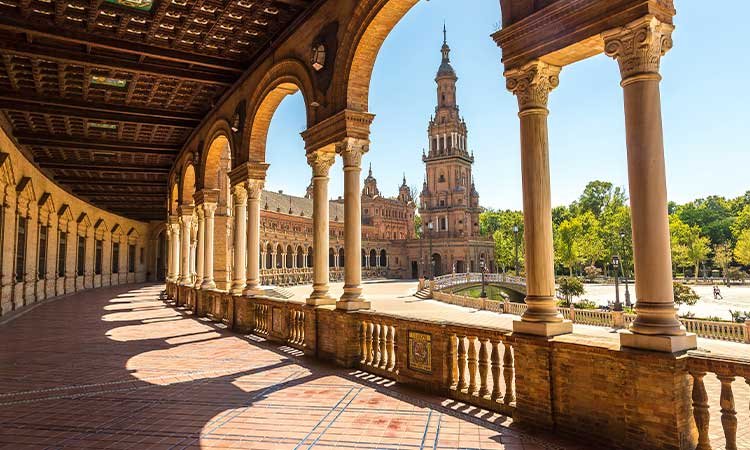 view from the underpass to the plaza espana in seville with the tower in the background, view through the round arches
